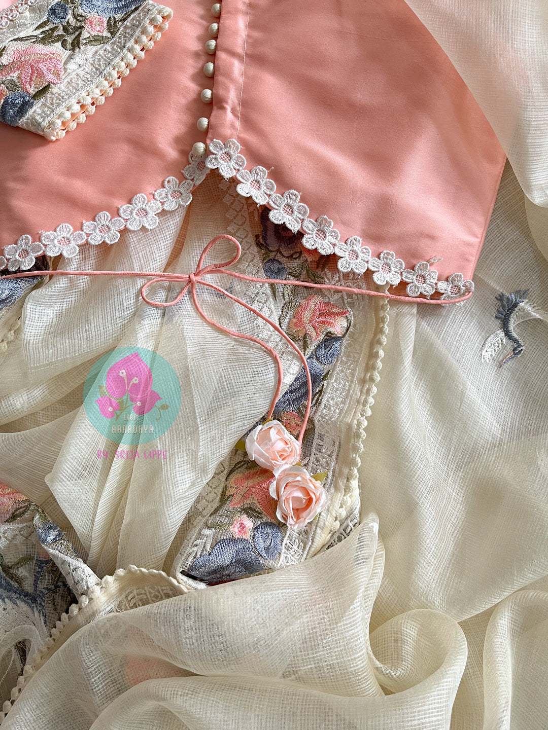 Pure tussar kota saree with beautiful flamingos paired with lace detailing peach blouse