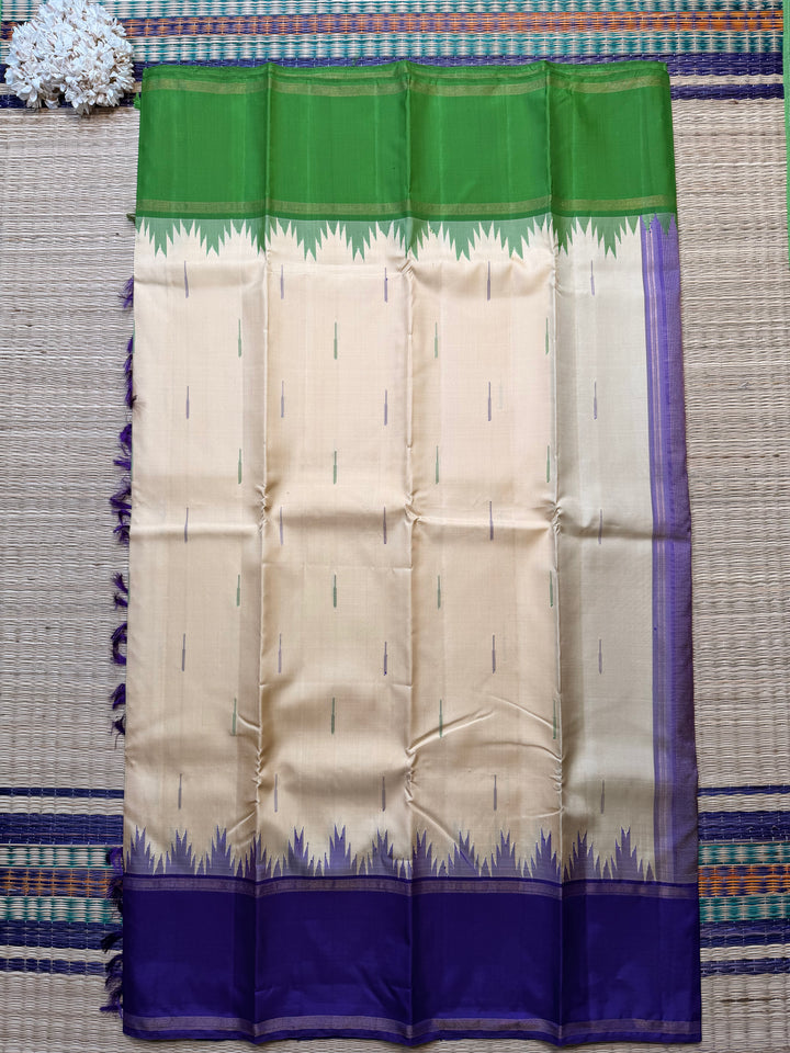 Ganga Jamuna border with rain drop weave & Ikkat Kanjivaram in Ivory, Green, and Royal Purple