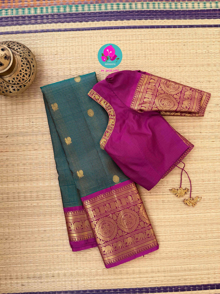Pure Kanchipattu treasure in Teal Green and Magenta color paired with hand embroidered blouse