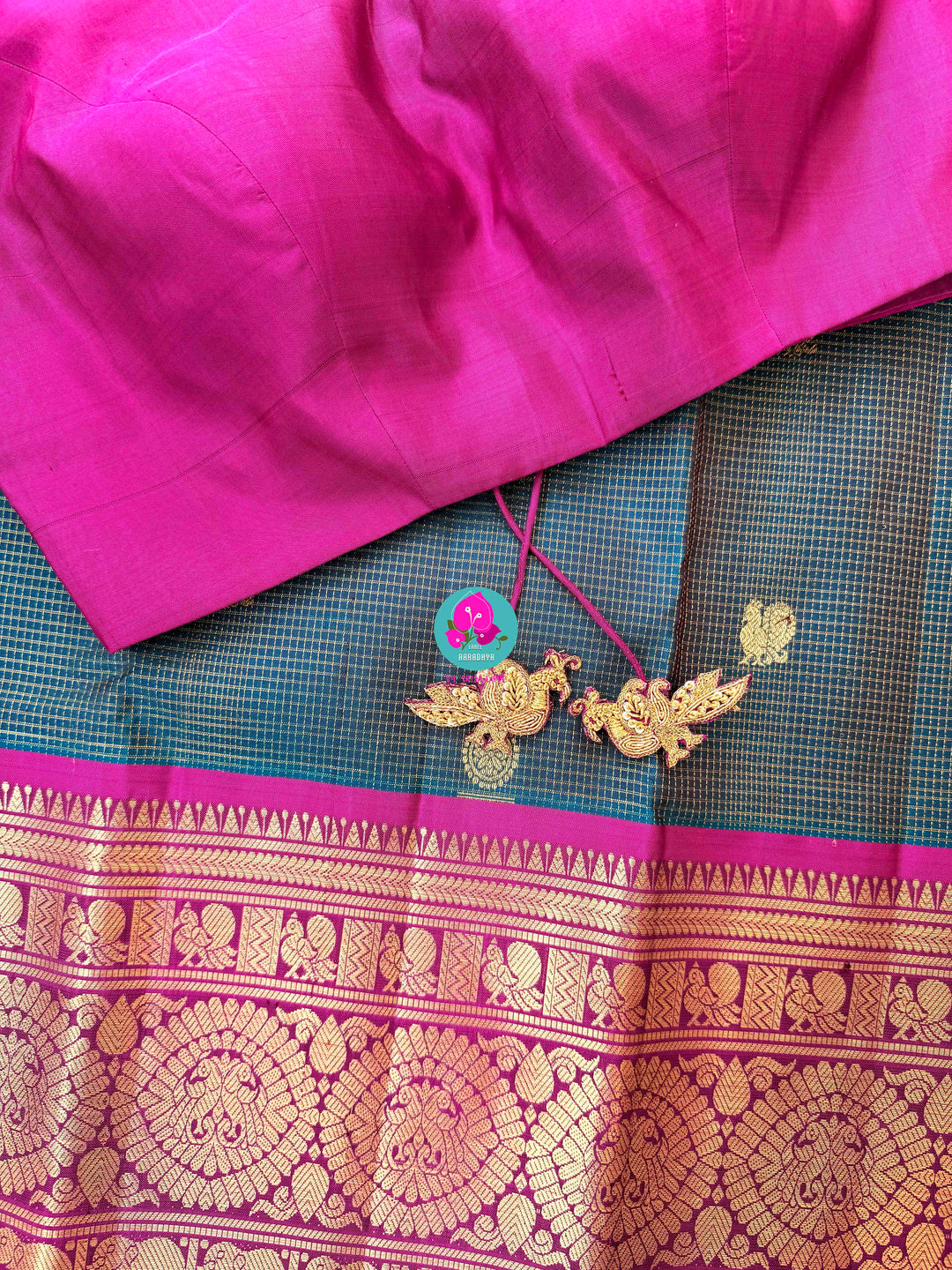 Pure Kanchipattu treasure in Teal Green and Magenta color paired with hand embroidered blouse
