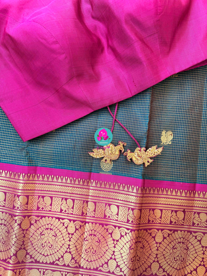 Pure Kanchipattu treasure in Teal Green and Magenta color paired with hand embroidered blouse