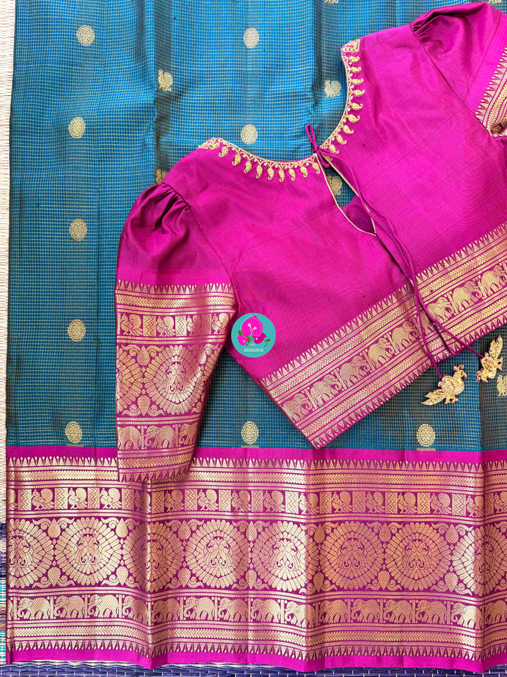 Pure Kanchipattu treasure in Teal Green and Magenta color paired with hand embroidered blouse