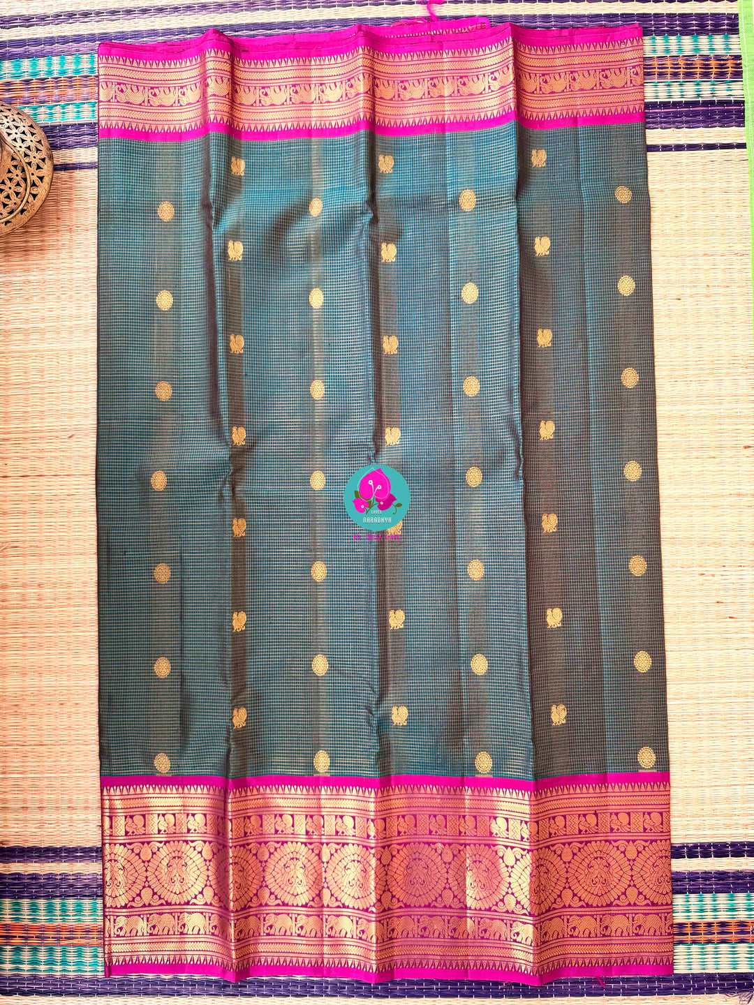 Pure Kanchipattu treasure in Teal Green and Magenta color paired with hand embroidered blouse