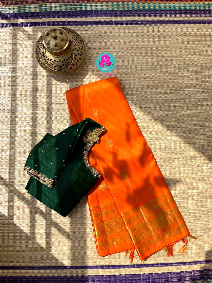 Pure Kanchipattu 3g zari Vaira oosi design on beautiful orange color paired with hand embroidered pure rawsilk blouse
