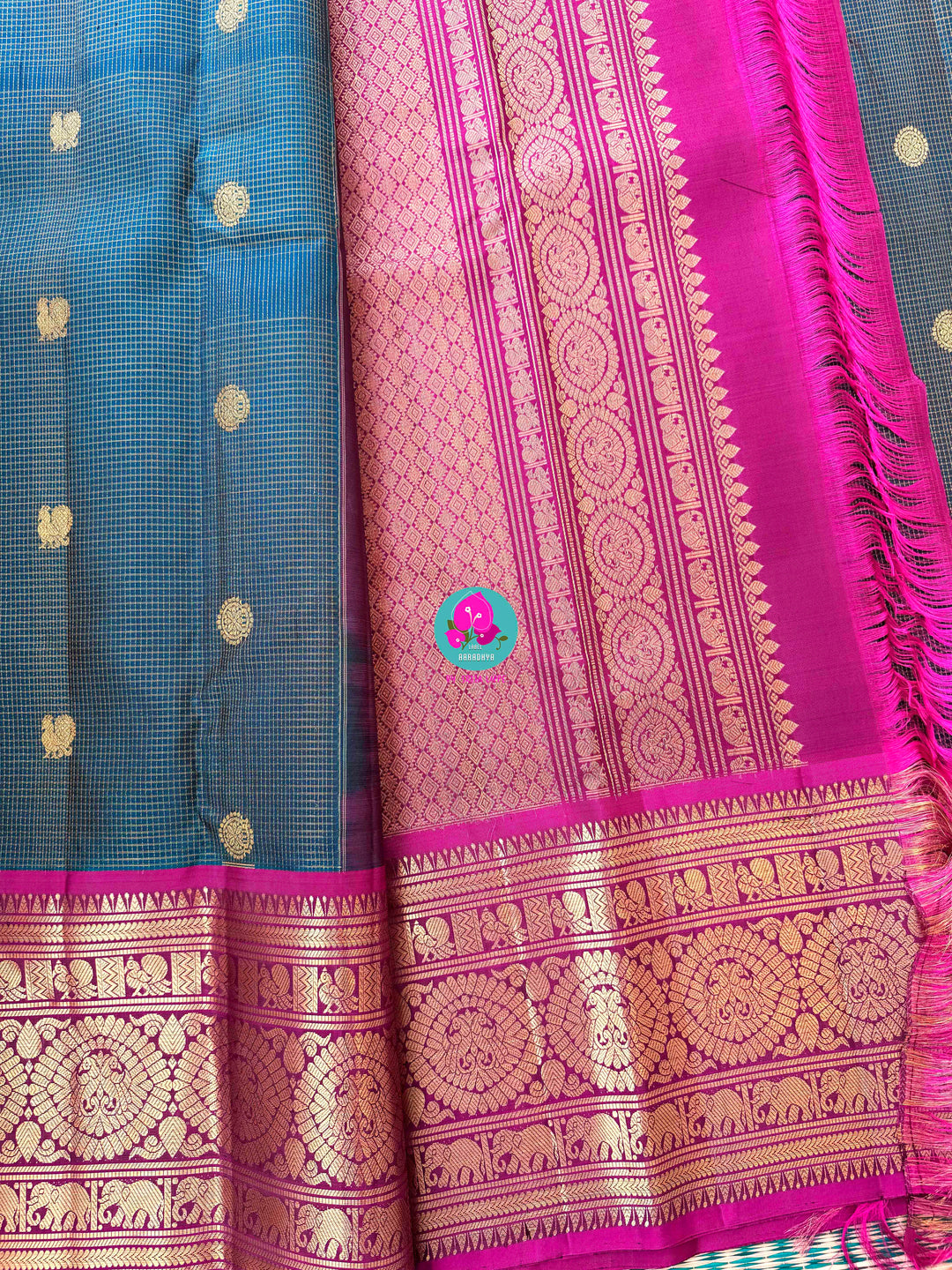 Pure Kanchipattu treasure in Teal Green and Magenta color paired with hand embroidered blouse