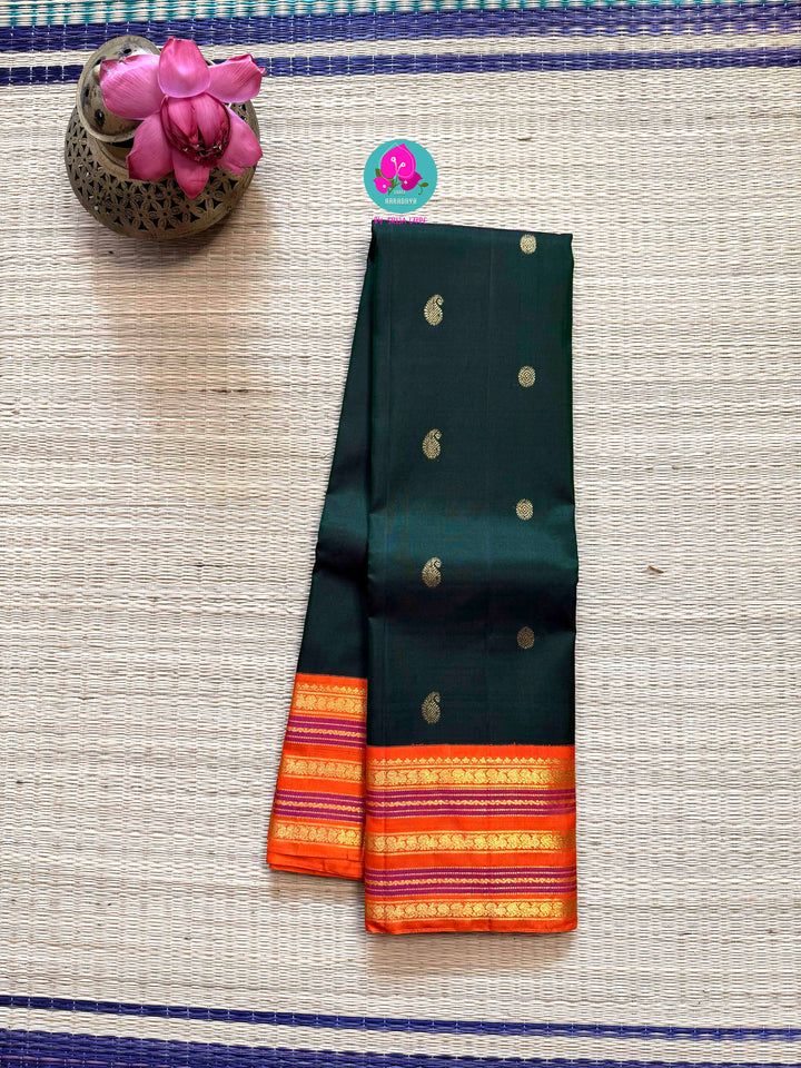 The Classic Contrast: Kanjivaram Silk Saree in Deep Green and Vibrant Orange