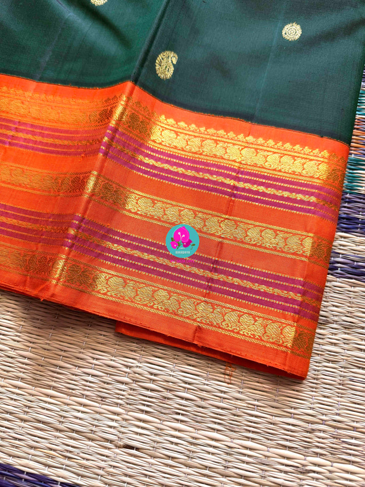 The Classic Contrast: Kanjivaram Silk Saree in Deep Green and Vibrant Orange