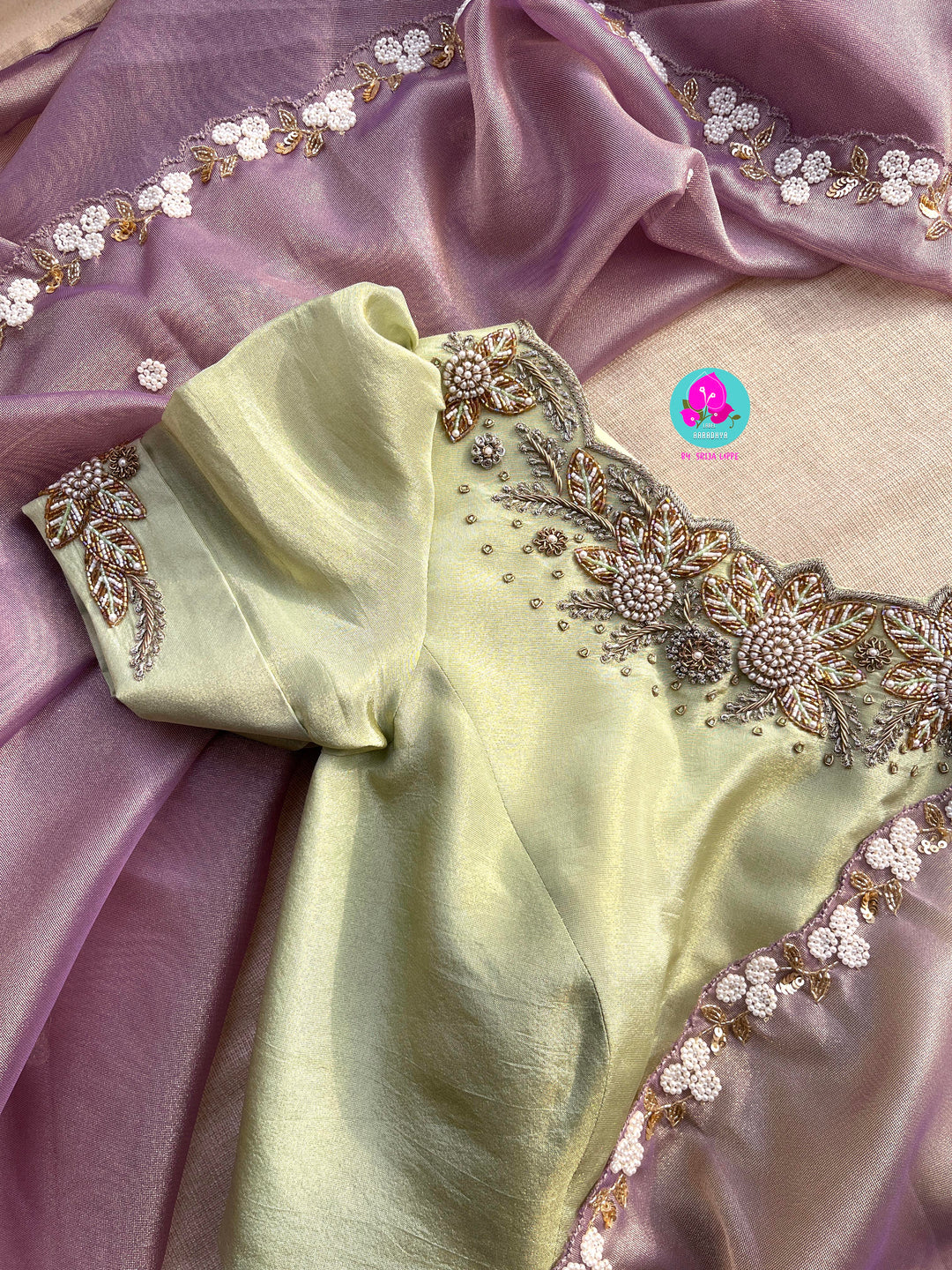 We call it a cocktail soft tissue silk saree with a flowy drape, paired with a hand embroidered blouse in matching tissue