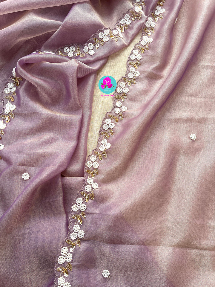 We call it a cocktail soft tissue silk saree with a flowy drape, paired with a hand embroidered blouse in matching tissue