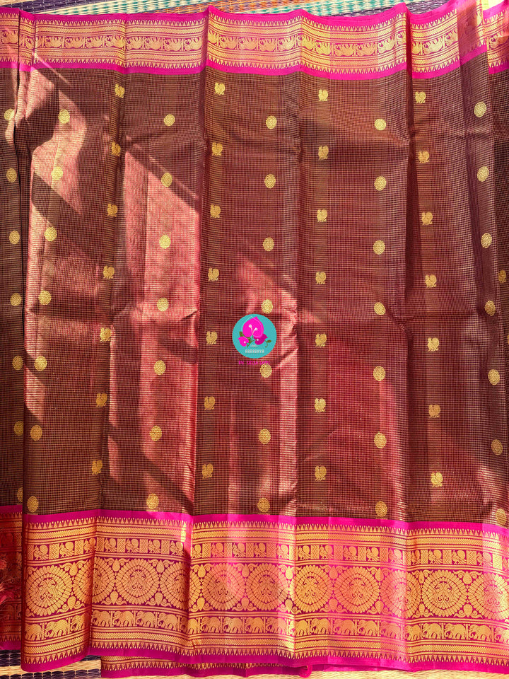 Pure Kanchipattu treasure in deep brown and Magenta color paired with hand embroidered blouse