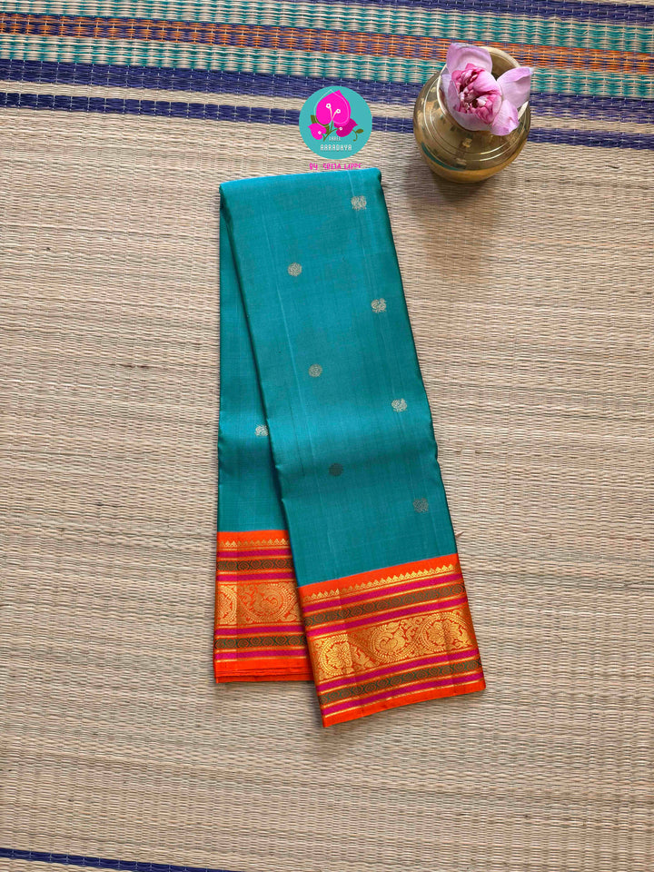 Night Sky Meets Sunrise: Dark Blue Kanjivaram Saree with Fiery Orange Contrast