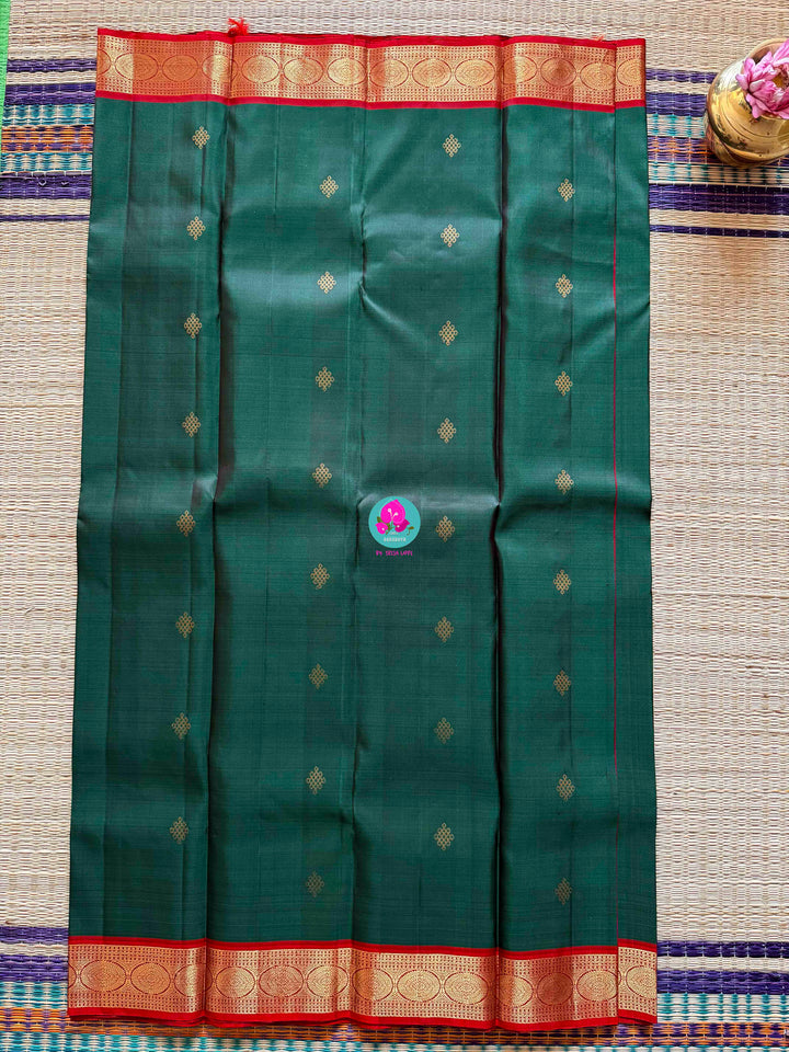 Auspicious Art: Bottle Green Kanchivaram silk Saree with Intricate Kolam Motif Weave