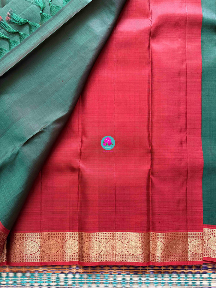 Auspicious Art: Bottle Green Kanchivaram silk Saree with Intricate Kolam Motif Weave