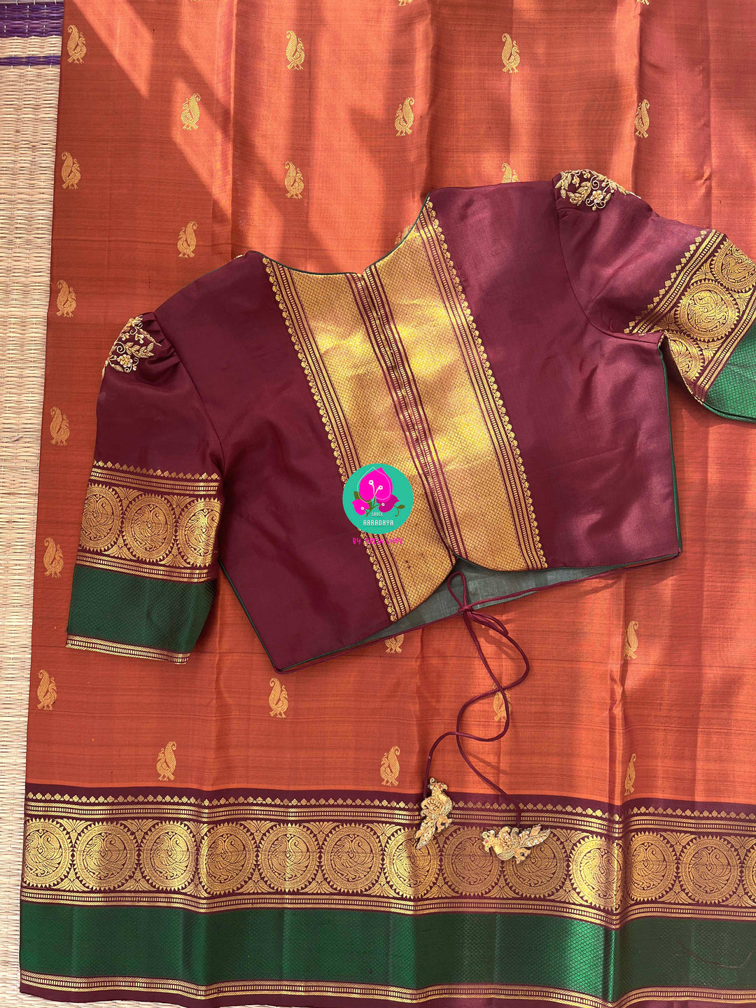 Kanchipattu handloom saree warm rust orange by a contrast border in sophisticated brown and a touch of vibrant green