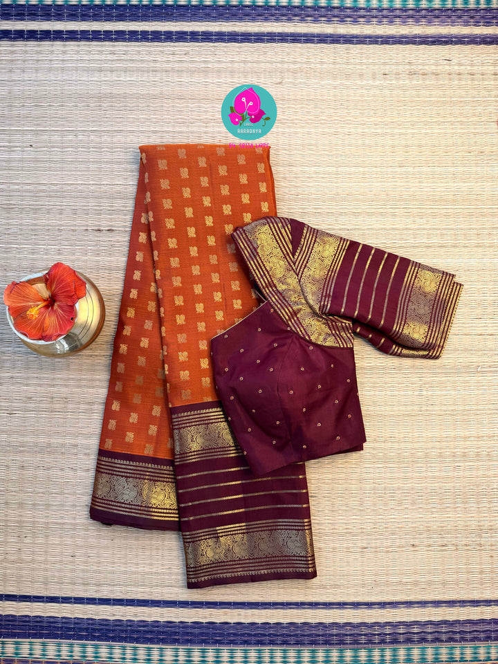 Earth's Glow: Vintage Orange Kanchipattu Saree with Majestic Peacock Border