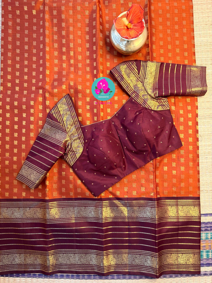 Earth's Glow: Vintage Orange Kanchipattu Saree with Majestic Peacock Border