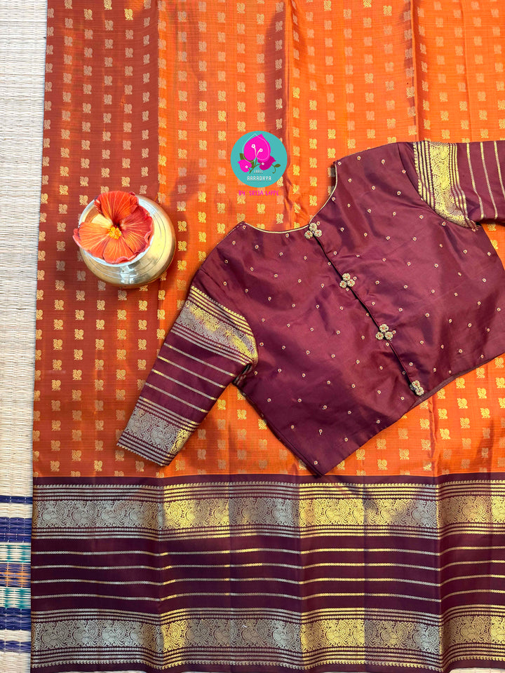 Earth's Glow: Vintage Orange Kanchipattu Saree with Majestic Peacock Border