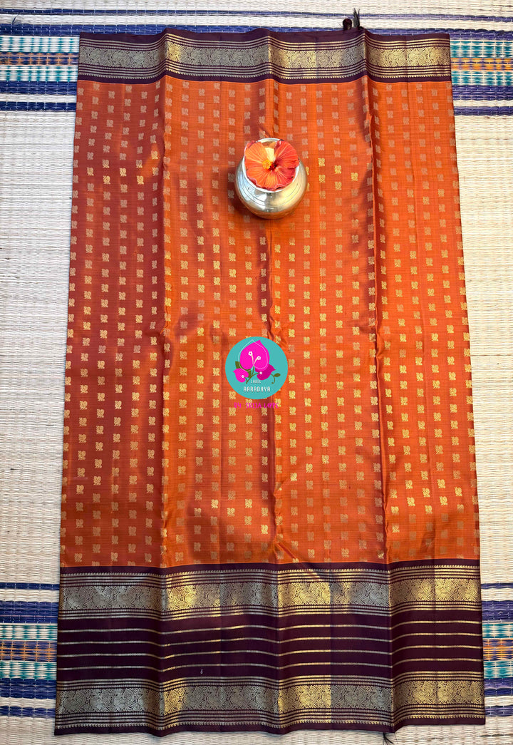 Earth's Glow: Vintage Orange Kanchipattu Saree with Majestic Peacock Border