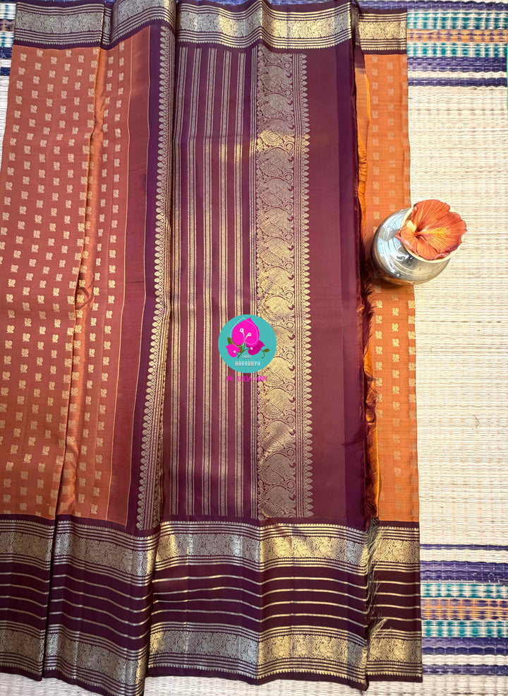Earth's Glow: Vintage Orange Kanchipattu Saree with Majestic Peacock Border
