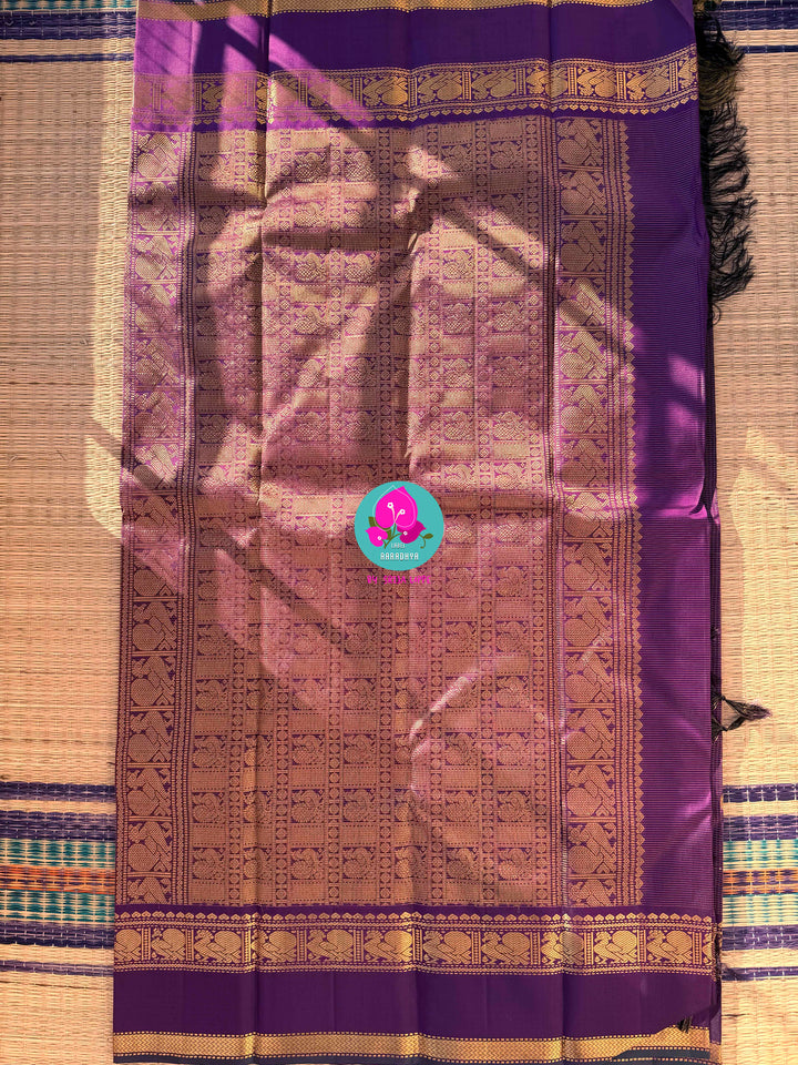 2g zari Vaira Oosi check butta saree in beautiful shade of purple with Hand Embroidered bottle green color fusion Blouse