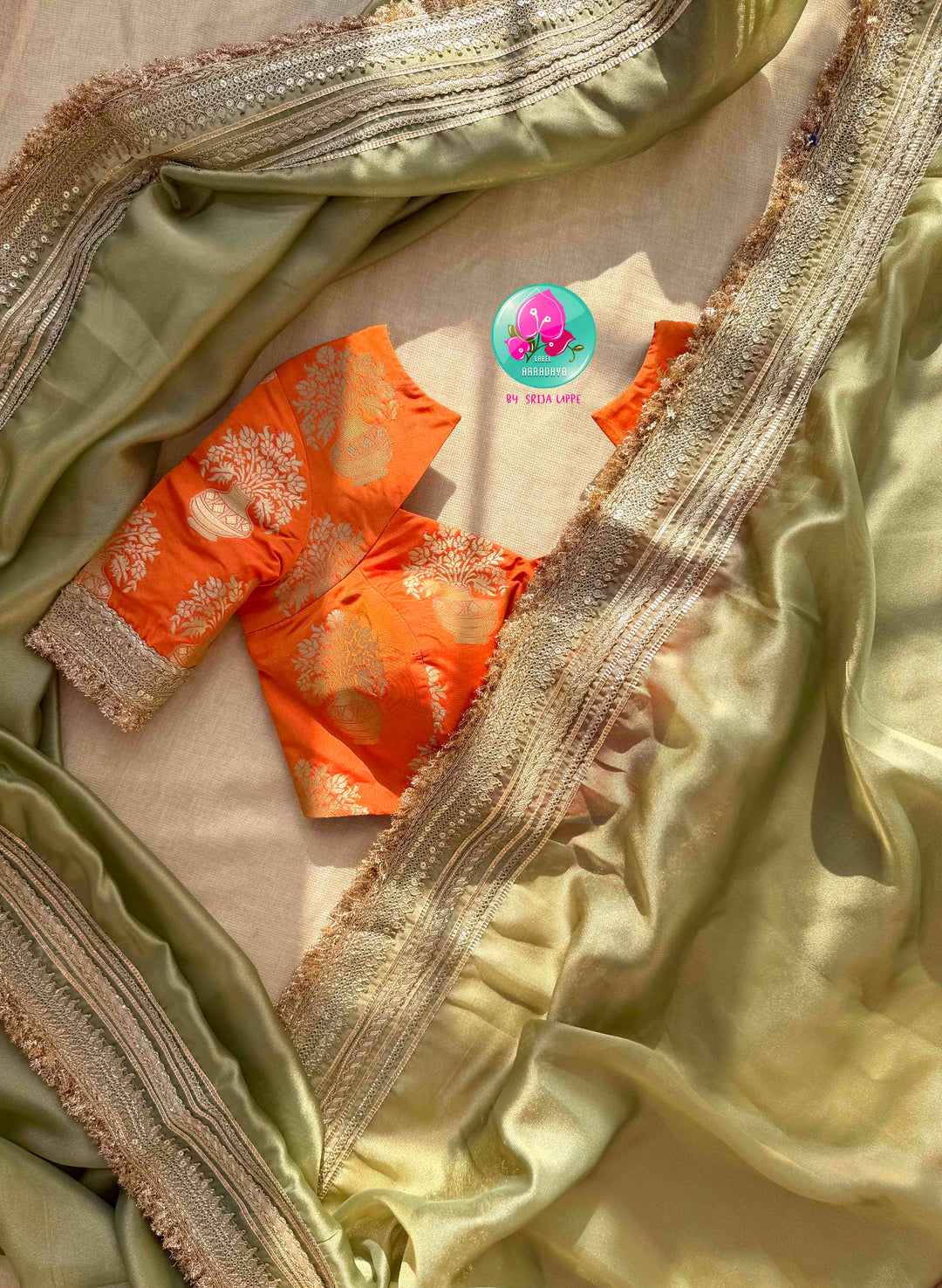 Ethereal Metallic Glow: Light Green Gold Tissue Organza Saree & Sunburst Orange Brocade Blouse