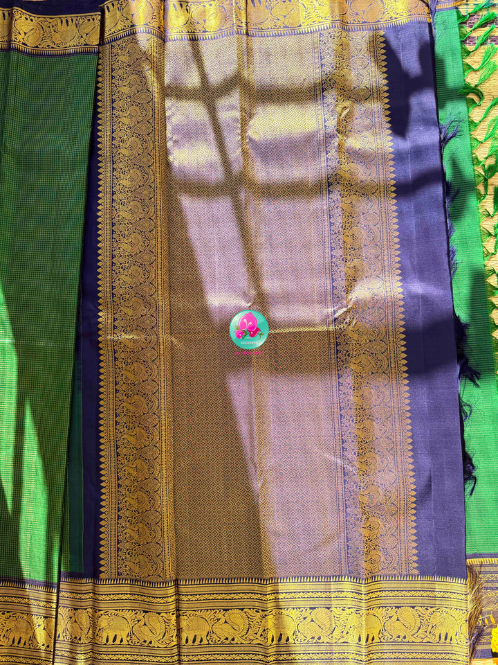Peacock Splendor: Emerald Green Vaira Oosi Kanchipattu Silk Saree & Royal Blue Maggam Blouse