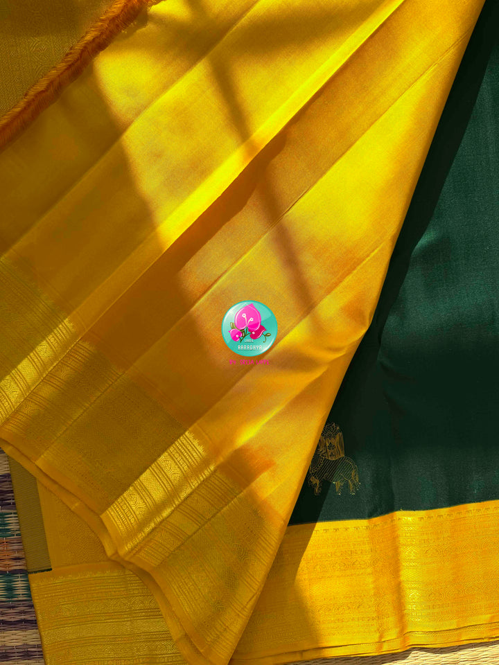 Sacred Pichwai Reverence: Bottle Green Pure Kanjeevaram Saree with Mustard Korvai Border & Kamadhenu Art