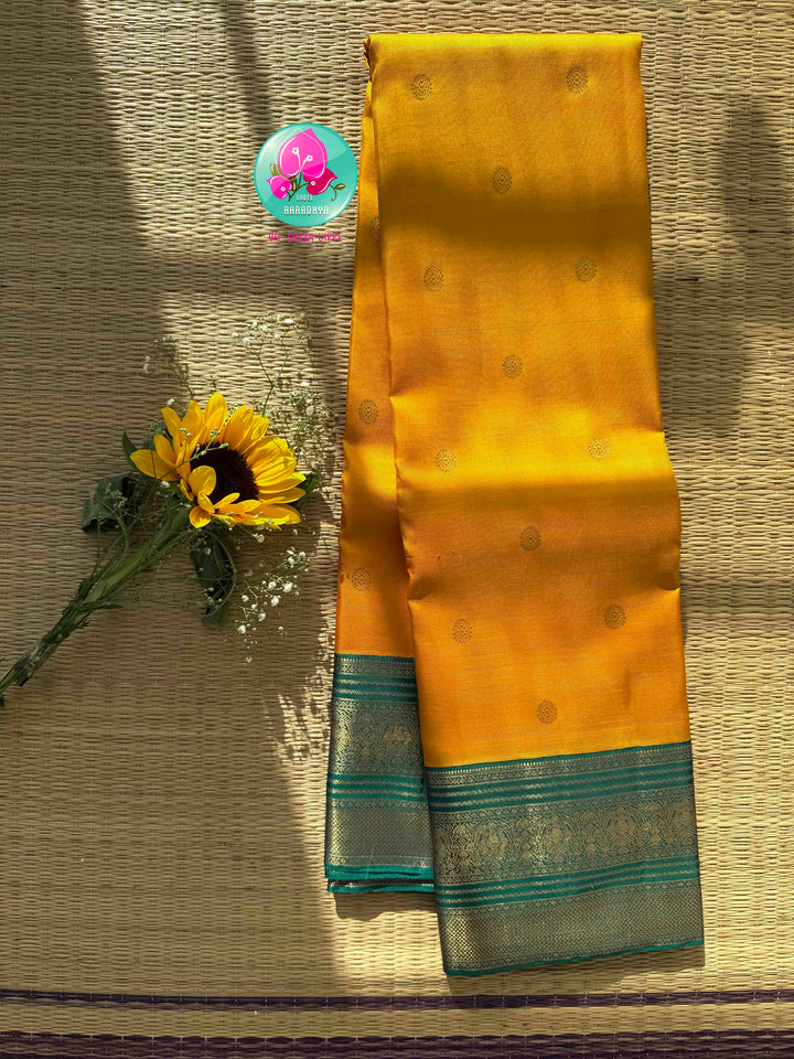 Vintage Radiance & Peacock Jewel: Mustard Yellow Pure Kanjeevaram Saree with Peacock Blue-Green Border