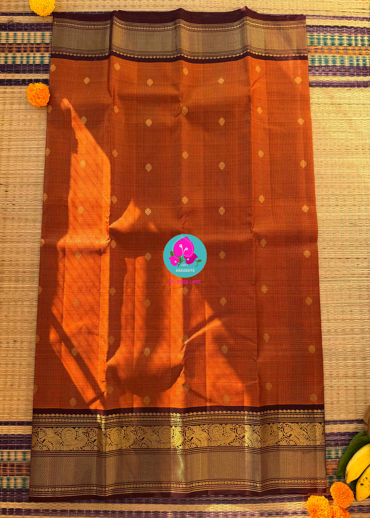 Deep Rust Kanchipuram Silk with Gilded Vaira Oosi & Hand-Embroidered Elegance