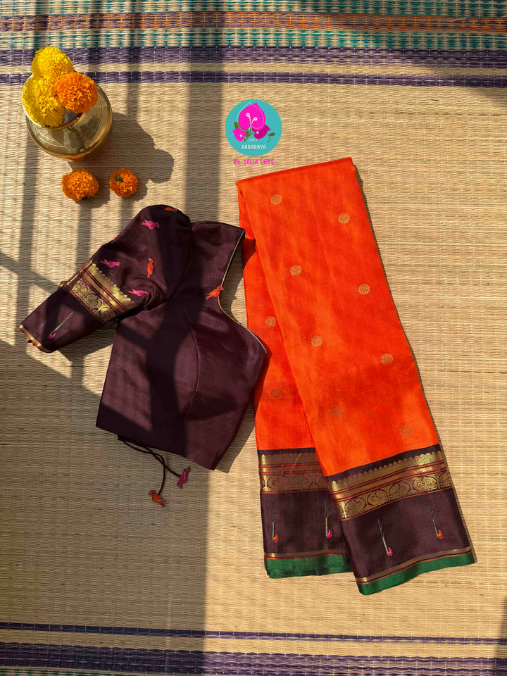 The Radiant Nectar: Vibrant Orange Kanchipuram Silk Saree with Chocolate Brown Borders & Hand-Embroidered Muniya Elegance