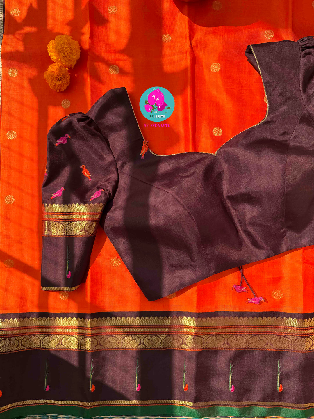 The Radiant Nectar: Vibrant Orange Kanchipuram Silk Saree with Chocolate Brown Borders & Hand-Embroidered Muniya Elegance