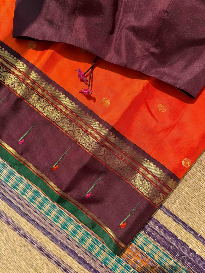 The Radiant Nectar: Vibrant Orange Kanchipuram Silk Saree with Chocolate Brown Borders & Hand-Embroidered Muniya Elegance