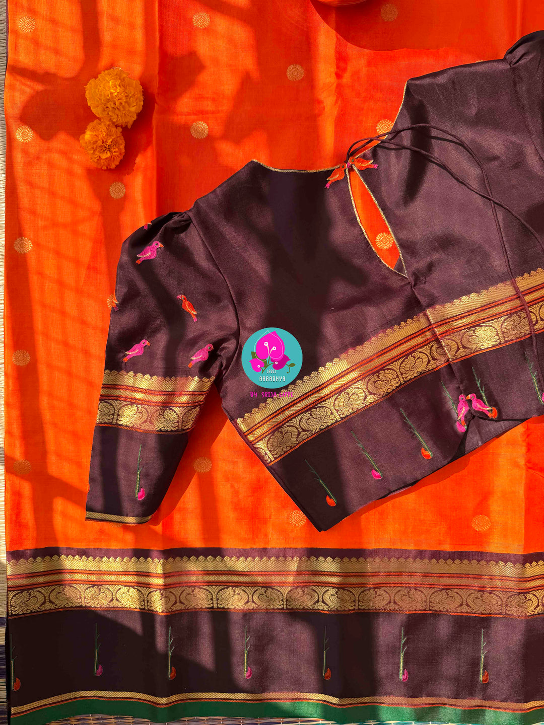 The Radiant Nectar: Vibrant Orange Kanchipuram Silk Saree with Chocolate Brown Borders & Hand-Embroidered Muniya Elegance