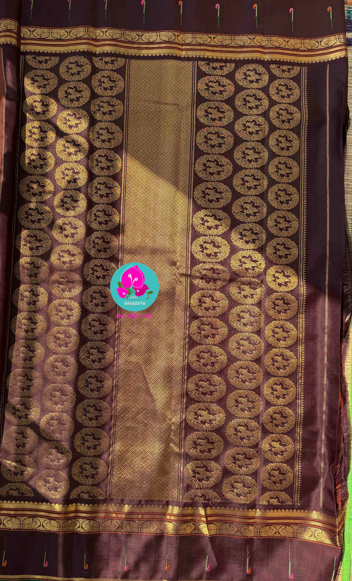 The Radiant Nectar: Vibrant Orange Kanchipuram Silk Saree with Chocolate Brown Borders & Hand-Embroidered Muniya Elegance