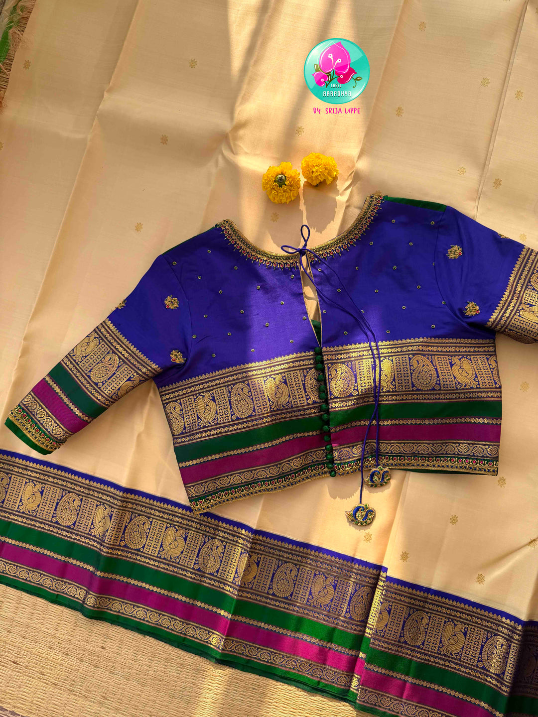 Understated Ivory Regalism: Cream Kanchipattu Silk Saree with Multi-Tone Heritage Border & Designer Maggam Blouse