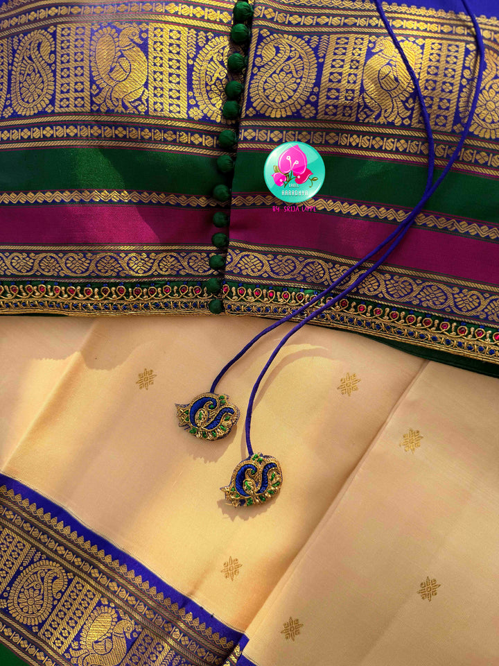 Understated Ivory Regalism: Cream Kanchipattu Silk Saree with Multi-Tone Heritage Border & Designer Maggam Blouse