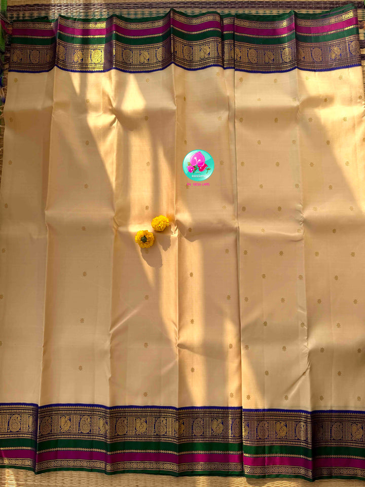 Understated Ivory Regalism: Cream Kanchipattu Silk Saree with Multi-Tone Heritage Border & Designer Maggam Blouse