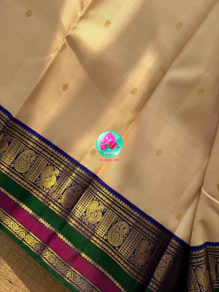 Understated Ivory Regalism: Cream Kanchipattu Silk Saree with Multi-Tone Heritage Border & Designer Maggam Blouse