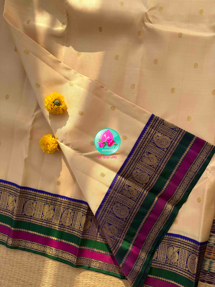 Understated Ivory Regalism: Cream Kanchipattu Silk Saree with Multi-Tone Heritage Border & Designer Maggam Blouse