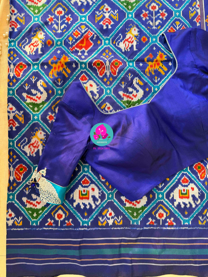 The Azure Odyssey: Royal Blue Double Ikkat Patola with Artisan Peacock Artistry