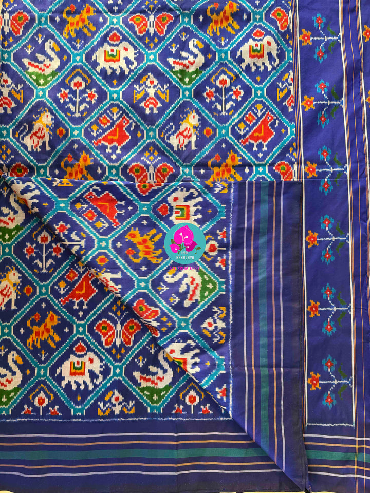 The Azure Odyssey: Royal Blue Double Ikkat Patola with Artisan Peacock Artistry