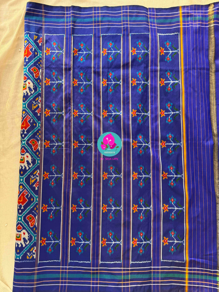 The Azure Odyssey: Royal Blue Double Ikkat Patola with Artisan Peacock Artistry
