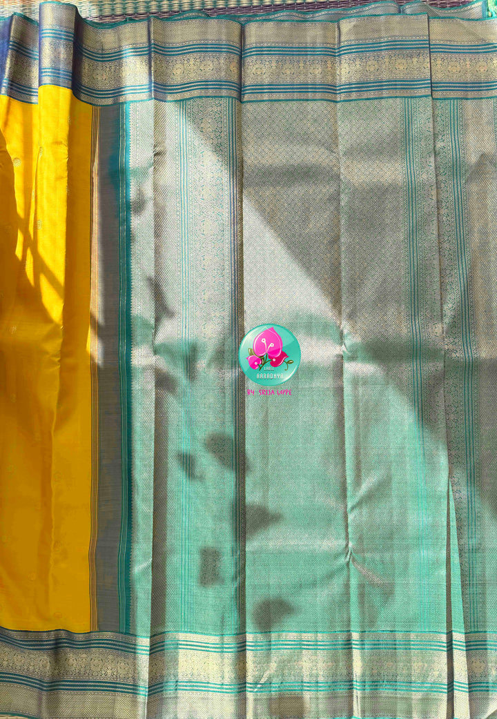 Vintage Radiance & High-Contrast Splendor: Mustard Yellow Pure Kanjeevaram Saree with Peacock Blue Border & Rani Pink Maggam Blouse