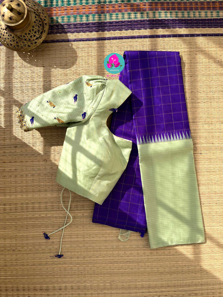 The Royal Jewel: Checkered Blue-Violet Silk Saree Paired with Hand-Embroidered Bird Blouse