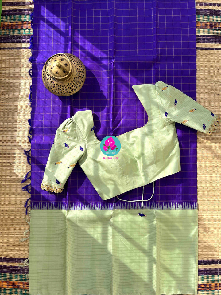 The Royal Jewel: Checkered Blue-Violet Silk Saree Paired with Hand-Embroidered Bird Blouse