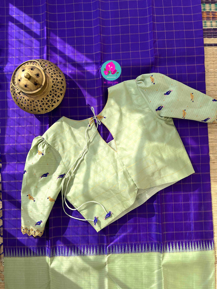 The Royal Jewel: Checkered Blue-Violet Silk Saree Paired with Hand-Embroidered Bird Blouse