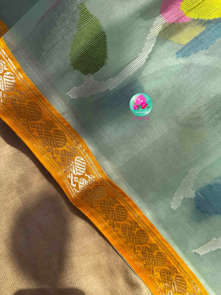 Ethereal Sheer Artistry: Powder Blue Jamdani-Kanchi Organza Silk Saree with Sunburst Mustard Raw Silk Blouse
