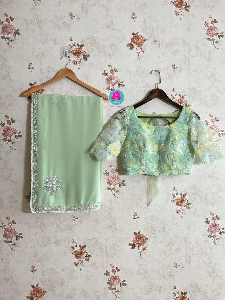 Hand embroidered georgette light Pista green saree with Embellished Net Fashion Blouse
