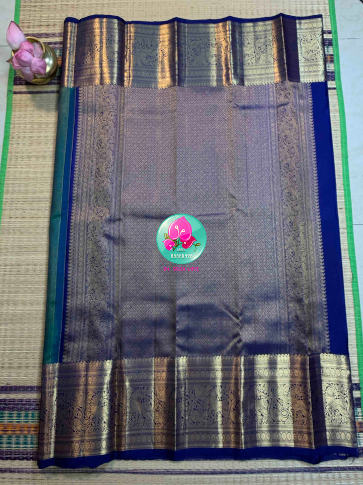 Gilded Peacock: Peacock Green Vaira Oosi Kanchipattu with Royal Blue Big Border