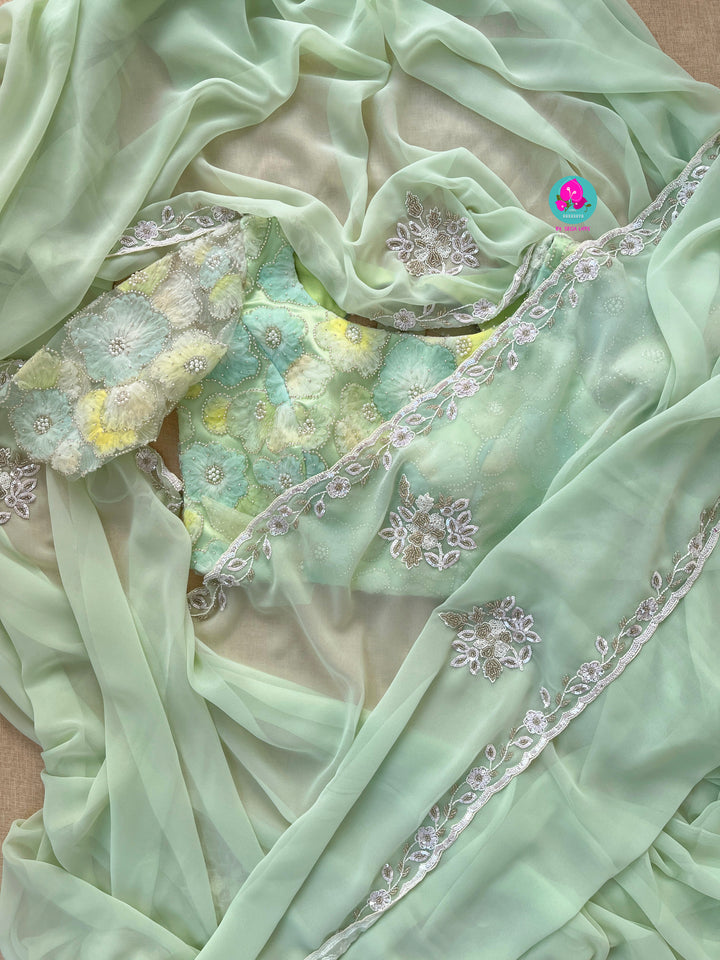 Hand embroidered georgette light Pista green saree with Embellished Net Fashion Blouse